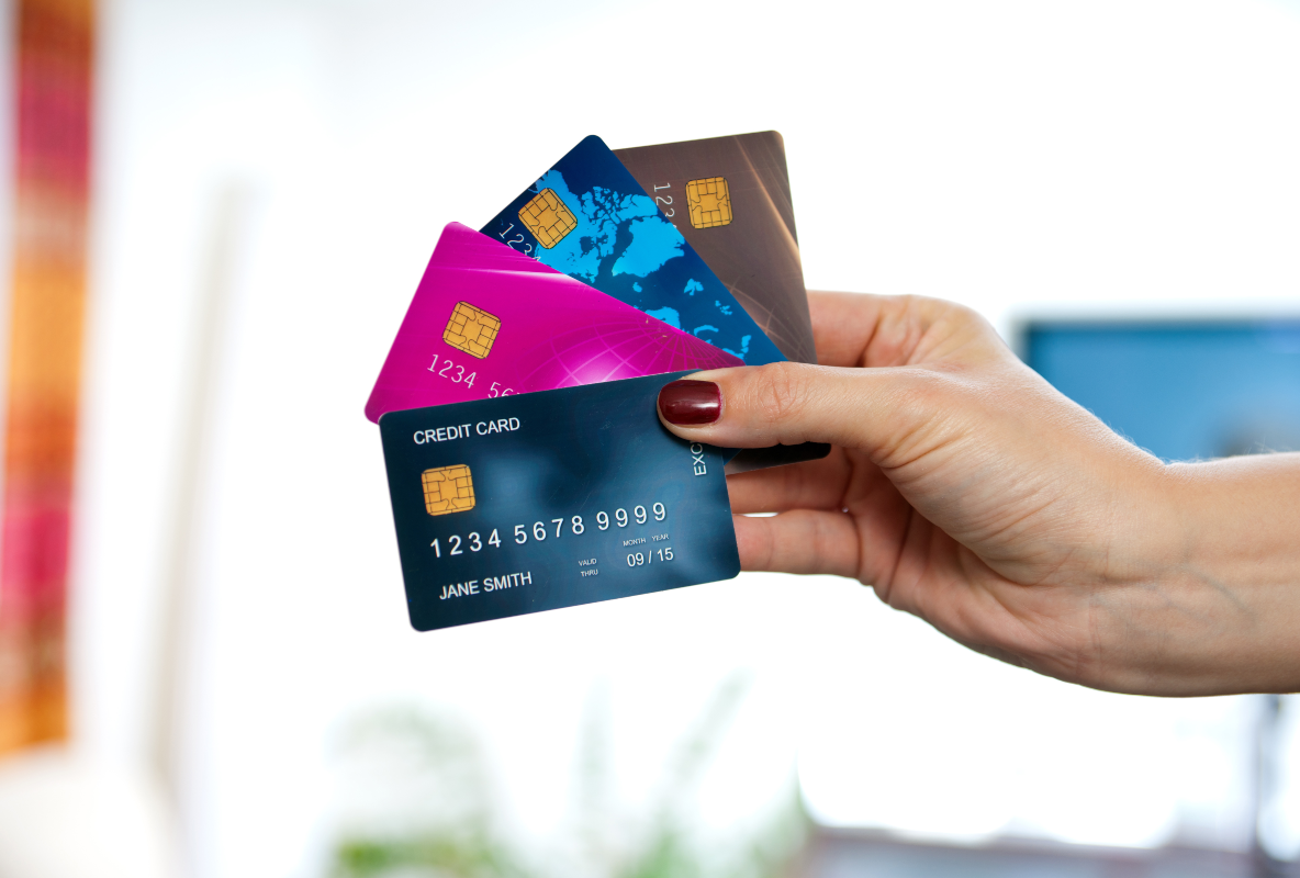 woman holding many credit cards