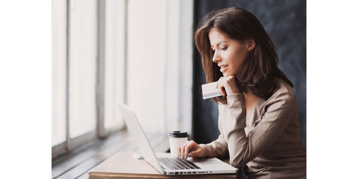 woman with payment card on computer